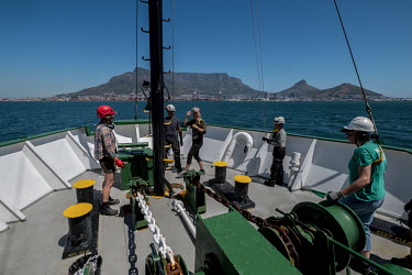 The crew of the Greenpeace vessel Arctic Sunrise lower the anchor off the coast of Cape Town, South Africa.