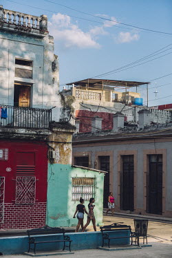Local residents walk through the San Isidro neighbourhood.