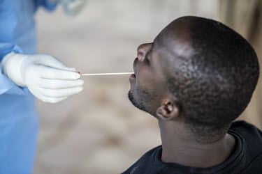 A nurse takes a swab sample for a COVID-19 test from a volunteer at the Fann university hospital.