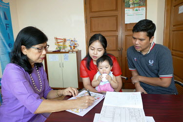 Nutritionist Thelma Tun Thein talks to Myintrso Hlaing (27) and Akayi Zin Ten (27) at the Parami General Hospital about nutrition and growth monitoring for their nine month old daughter Poe Thadar Phy...