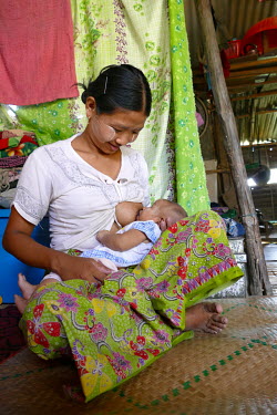 Moe Moe Win (22) breastfeeding her two month old baby at her home in the Shwe Pyi Thar district.