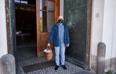 Darek in a homemade face mask, a Polish man living in Czech Republic, holding a basket with Easter bread (Paskha), painted eggs and sausages that were blessed by a pastor in the Church of the Most Sac...
