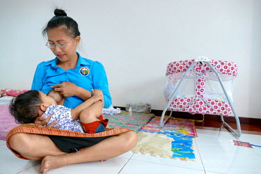 Laddavanh Phanthavong (Tik) breastfeeding her child Nino Phanthavong (19 months) in her workplace creche. Tik, a first-time mother in her early thirties, works in the finance section at the Laos Women...