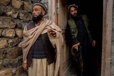 Commander Roja Gul (46, L) with a bodyguard Hamidullah (R), a former Afghan army soldier. Gul's Taliban group have aligned with a faction led by Mullah Manan Niazi that has itself joined Mullah Rasool...