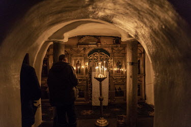 Visitors explore and pray in the caves of the Lavra monastery, home to the remains of some the most revered orthodox saints.