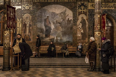 Worshippers attend an evening service at one of the churches at the Kiev-Pechersk Lavra monastery, which remains under the control of Moscow despite the split between the Russian and Ukrainian Orthodo...