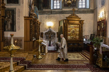A priest walks through a small church at the Kiev-Pechersk Lavra monastery, which remains under the control of Moscow despite the split between the Russian and Ukrainian Orthodox Churches.