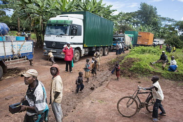 A queue of trucks forms after a vehicle became stuck in the mud on the road from Mahagi to Bunia during the rainy season.
