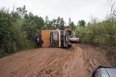 A truck that has toppled over on the muddy and uneven road to Bunia, made harder to navigate due to the rainy season.