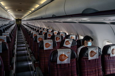 A solitary passenger sits on a near empty domestic flight from Bangkok to Phuket.