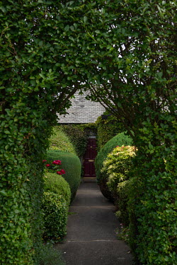 A door hidden by hedges and topiary in Blackhall.  Hedges offer increased privacy, isolating the homeowner and emphasising the division of public and private space. Where boundaries between properties...