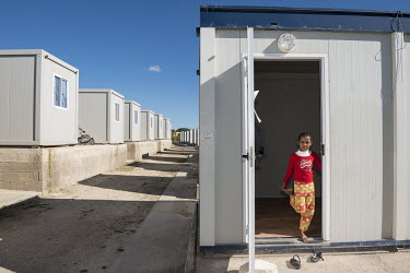 A Somalian migrant girl in front of her 'container house' in the 'Tent Village Open Centre'. A container house accomodates up to two families or eight individuals. Most residents are Africans, predomi...