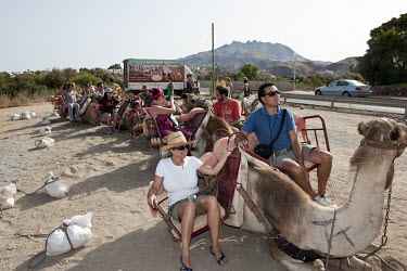 Tourists on a camel trip along the Mediterranean coast.