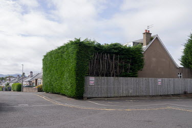 A large hedge surrounds a house in Craigleith.  Hedges offer increased privacy, isolating the homeowner and emphasising the division of public and private space. Where boundaries between properties me...