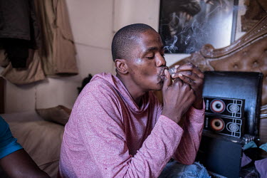 A youth smokes mandrax at a house during the coronavirus lockdown.