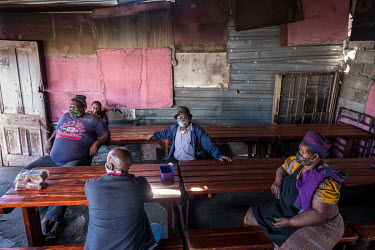 People sitting in a restaurant that is struggling to survive due to the loss of income brought about by the government's lockdown restrictions.