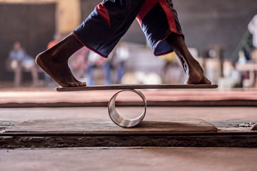 An acrobat from the Tinafan circus school, tests his balance during training at the Centre Keita Fodeba.