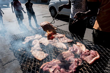 Men grilling meat at a street stall in the Nyanga township. The stand was previously destroyed by police for breaching coronavius restrictions, but the owner felt there was no choice but to reopen any...