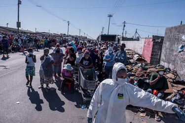 People queue up to receive food donations in the Gugulethu township where, as in many of the country's townships, people have been strugging financially since the country went into coronavirus lockdow...