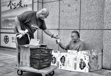 Okinawa-resident, American Warren Sanchez (left) handing out meals and water to homeless people at Taipei Main Station. Sanchez, who, along with his daughter JJ runs an 'Asian-Cajun' restaurant in Oki...