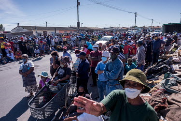 People queue up to receive food donations in the Gugulethu township where, as in many of the country's townships, people have been strugging financially since the country went into coronavirus lockdow...