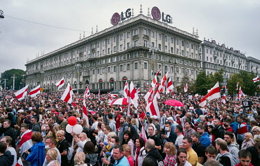 Activists wave red and white flags, adopted by the Belarusian opposition, during an anti-government, pro-democracy demonstration in the centre of Misnk. More than 100,000 protesters were involved in t...