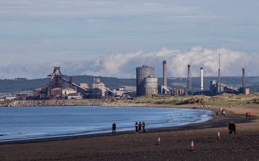 People on the beach at Seaton Carew with the closed-down Redcar Steelworks in the background. Redcar Steelworks was unable to compete with cheaper foreign steel producers and was shut down. This has h...