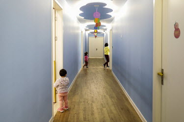 A member of staff plays with children in a kindergarten (creche) catering to employees of travel company Ctrip.com (part of the Trip.com Group Ltd.) at their headquarters in the Sky Soho building.