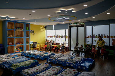 Children getting ready for nap time in a kindergarten (creche) catering to employees of travel company Ctrip.com (part of the Trip.com Group Ltd.) at their headquarters in the Sky Soho building.