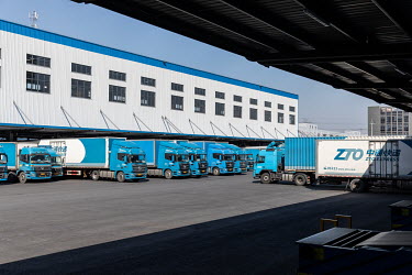 Haulage trucks line up in an unloading area of a ZTO Express Inc. sorting facility. Package delivery billionaires, including the founder of ZTO Express, have seen their fortunes swell as online shoppi...