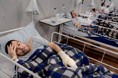 Luciano Bertarello (39), who is suffering from COVID-19, lies in his bed in an indoor stadium temporarily converted into a field hospital as authorities try to cope with the rising number of COVID-19...