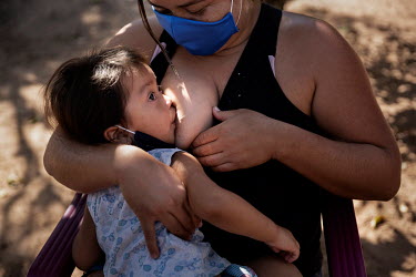 Rosangela Pereira Vieira, an indigenous Terena woman in the village of Moreira, breastfeeding her daughter Ana Clara (2) who has tested positive for COVID-19. Her mother believes she might have contam...