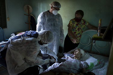 Doctors from Samu (emergency mobile care service) attend to Balbina de Paula Santos (99),who lives with her daughter in a house in Campo Grande. Despite her 99 years, she's been healthy and clear in h...