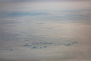 A view of the smog covered city of Baoding, seen from a passing aeroplane.