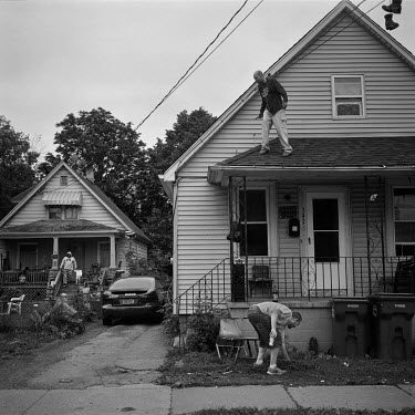 Friends Jason (36, on the roof) and Jerry (30), working on a house on 19th Street.  ''It's the most craziest city, everybody does everything, drugs, prostitution. Even kids are doing weird stuff. You...