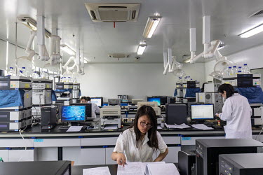 A technician reads a document in a quality control laboratory at a China Grand Pharmaceutical and Healthcare Holdings Ltd. facility.