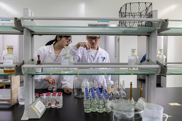 Technicians work in a quality control laboratory at a China Grand Pharmaceutical and Healthcare Holdings Ltd. facility.