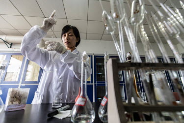 A technician conducts a test in a quality control laboratory at a China Grand Pharmaceutical and Healthcare Holdings Ltd. facility.