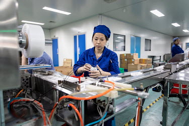 An employee works on a production line that manufactures eye solutions at a China Grand Pharmaceutical and Healthcare Holdings Ltd. facility.