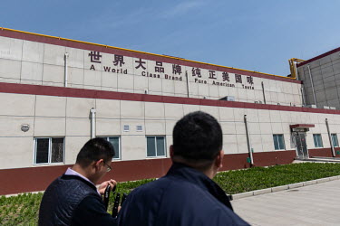 Employees walk through the factroy grounds of a WH Group Ltd. facility. WH Group opened a 800 million Yuan (USD 116 m, 90 m GBP) factory in Zhengzhou that will produce 30,000 metric tons of sausage, h...