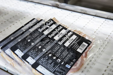 Packages of bacon produced from imported pork meat, supplied by Smithfield Foods Inc., at the end of a production line at a WH Group Ltd. facility that processes the pork into ham, bacon etc. As China...
