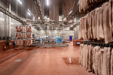Employees handle racks of imported pork bellies, supplied by Smithfield Foods Inc., that will be processed into bacon on a production line at a WH Group Ltd. facility. As China prohibits imports of pr...