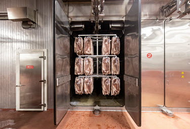Racks of imported pork bellies, supplied by Smithfield Foods Inc., during the bacon curing process at a WH Group Ltd. facility. As China prohibits imports of processed meat, WH Group acquired American...