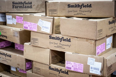 Boxes of imported pork bellies, supplied by Smithfield Foods Inc., are stacked at the beginning of the production line that processes the pork into bacon at a WH Group Ltd. facility. As China prohibit...