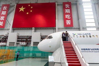Visitors exit a mock up of the Commercial Aircraft Corp. of China Ltd. (Comac) C919 aircraft at the Comac Shanghai Research and Development Center.