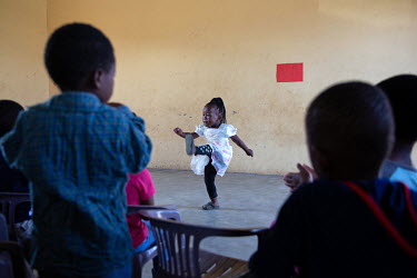 Children dance during activities a community centre (NCP) where children attending receive support and food.