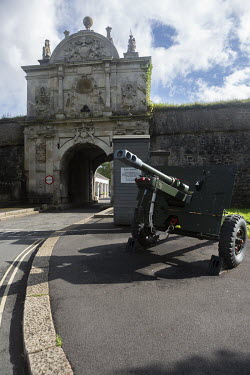 A howitzer gun stands at the entrance to the Citadel which is still used as a barracks for the Royal Artillery.