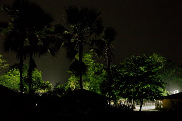 Bright lights illuminate the village after dark following the installation of a solar power grid paid for by the community which supplies street lighting and, for a monthly subscription, electricity t...