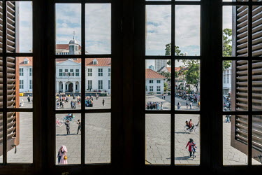People in Batavia Square, in the 500 year old original Dutch quarter.