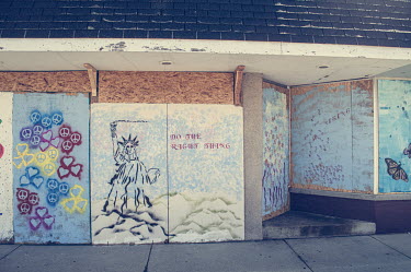 Murals painted on a boarded over building following protests, some violent, against the police shooting of Jacob Blake.